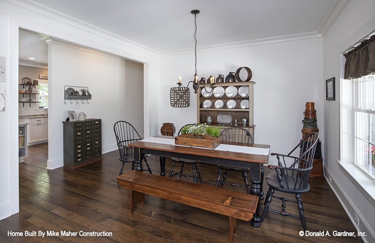 Formal dining room with a display cabinet and a rectangular dining table paired with a matching bench and round back chairs.