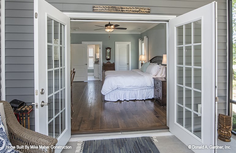 A french door extends the primary bedroom onto a screened porch.