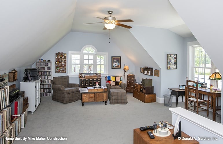 Bonus room with a vaulted ceiling, carpet flooring, a sitting area, and a study nook.