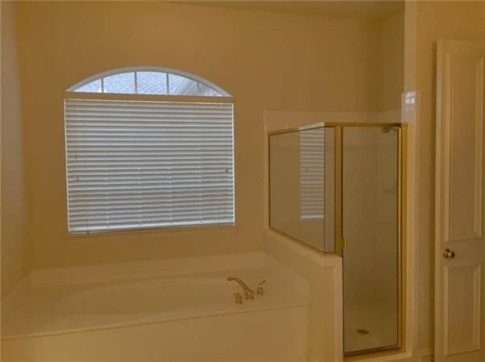 A drop-in bathtub and walk-in shower complete the primary bathroom.