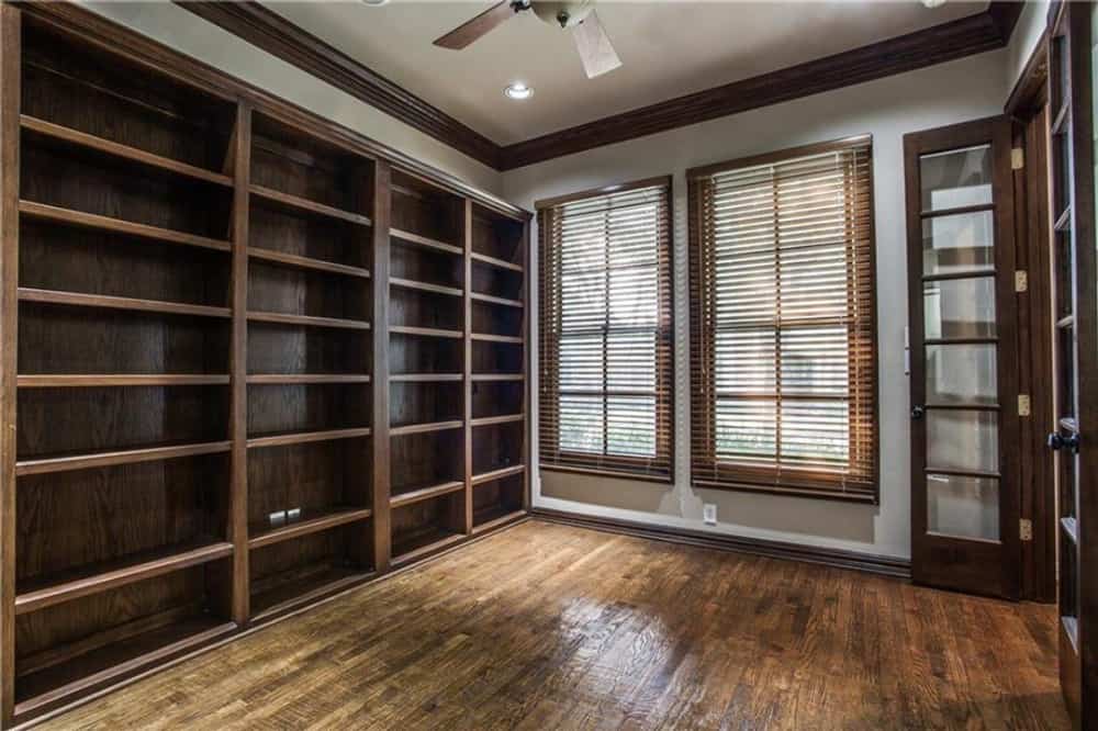 Heavy wooden elements run throughout the study. There are also framed windows bringing natural light in.