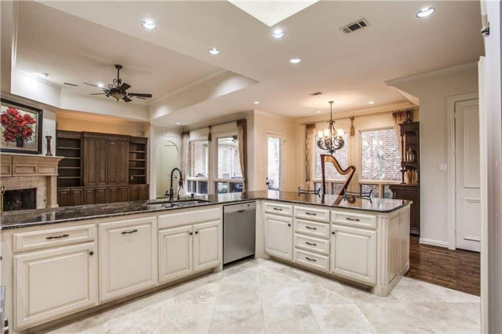 A beige velvet rug defines the kitchen from the open living space.