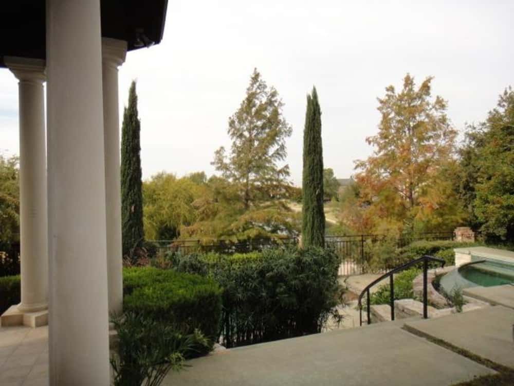 Veranda with round columns and an amazing view of the expansive surrounding.