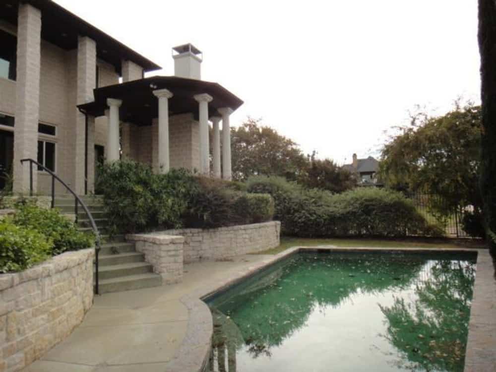 The veranda includes a swimming pool bordered by flagstone paving.