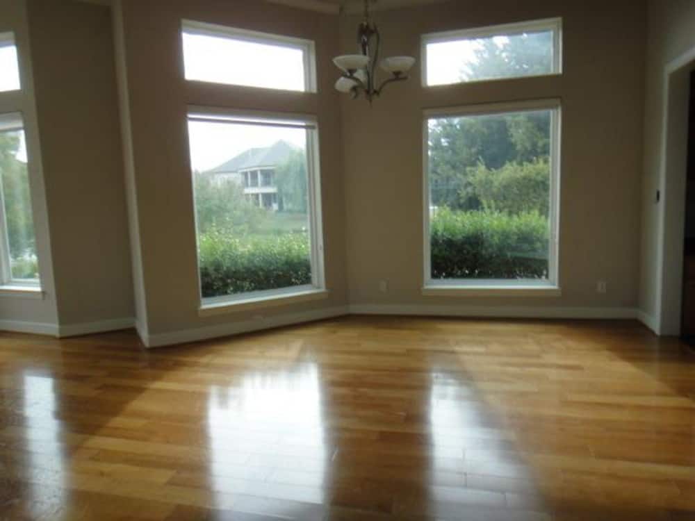 Breakfast nook with hardwood flooring, bay window, and a classic chandelier.