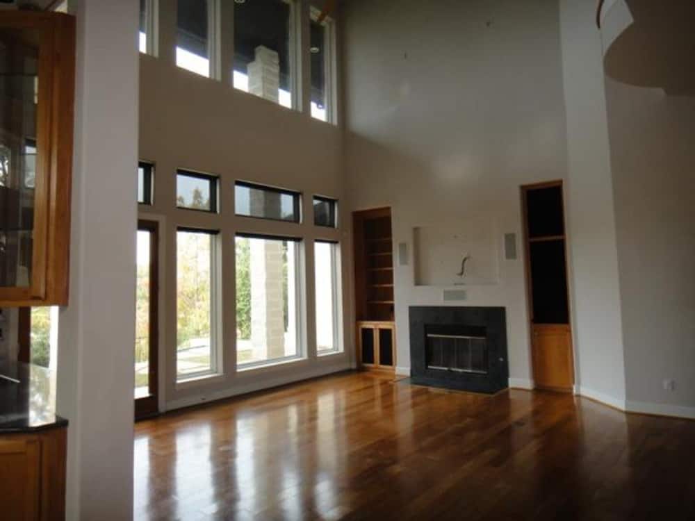 Family room with a modern fireplace, wooden built-ins, and clerestory windows that bring ample natural light in.