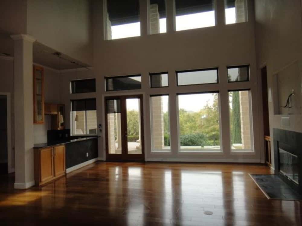 The family room includes a fun wet bar with wooden cabinets and granite counters.
