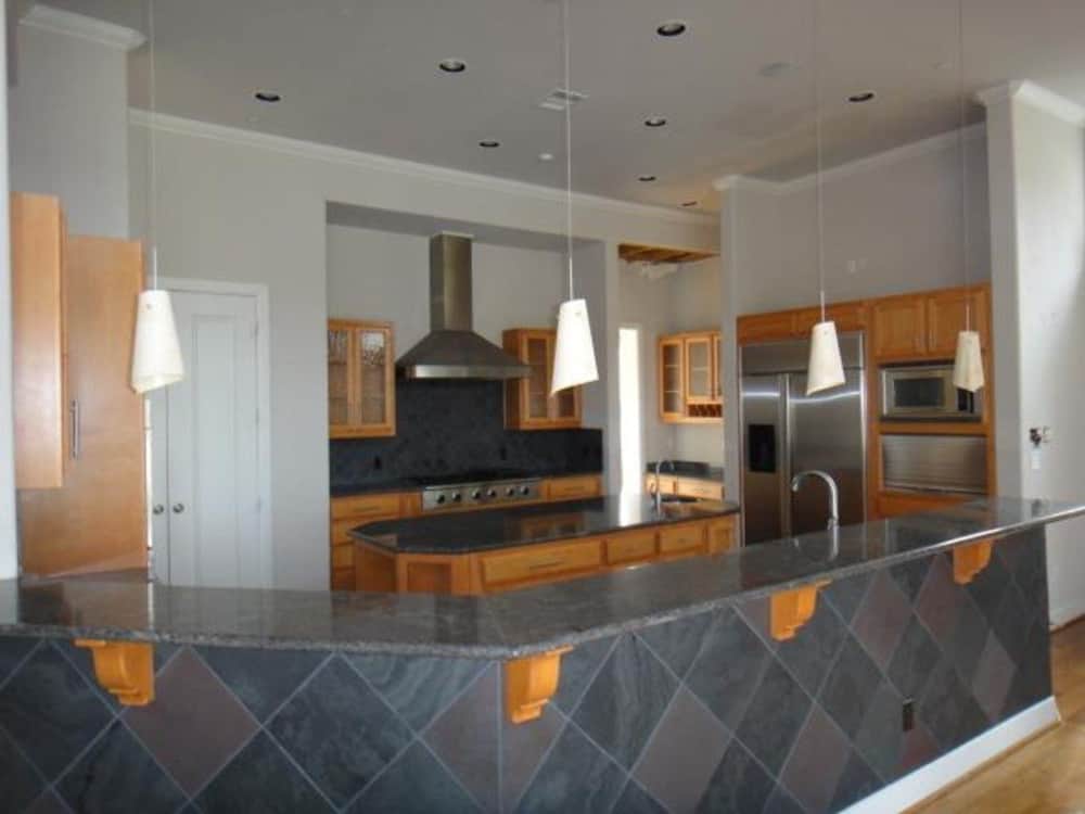 Kitchen with wraparound counters, wooden cabinets, and a center island.