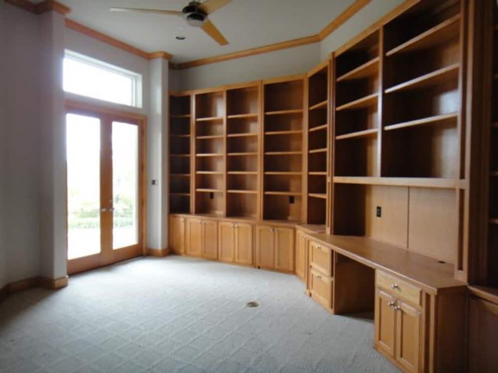The study has built-in bookcases and a desk along with a french door that leads onto the veranda.