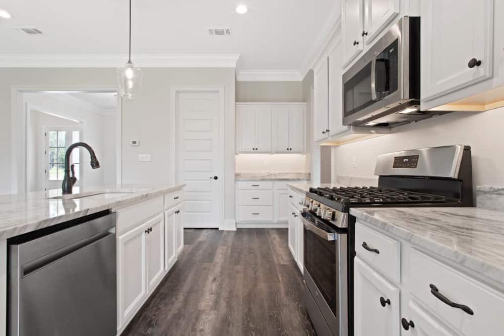 The kitchen includes a walk-in pantry concealed behind the white door.