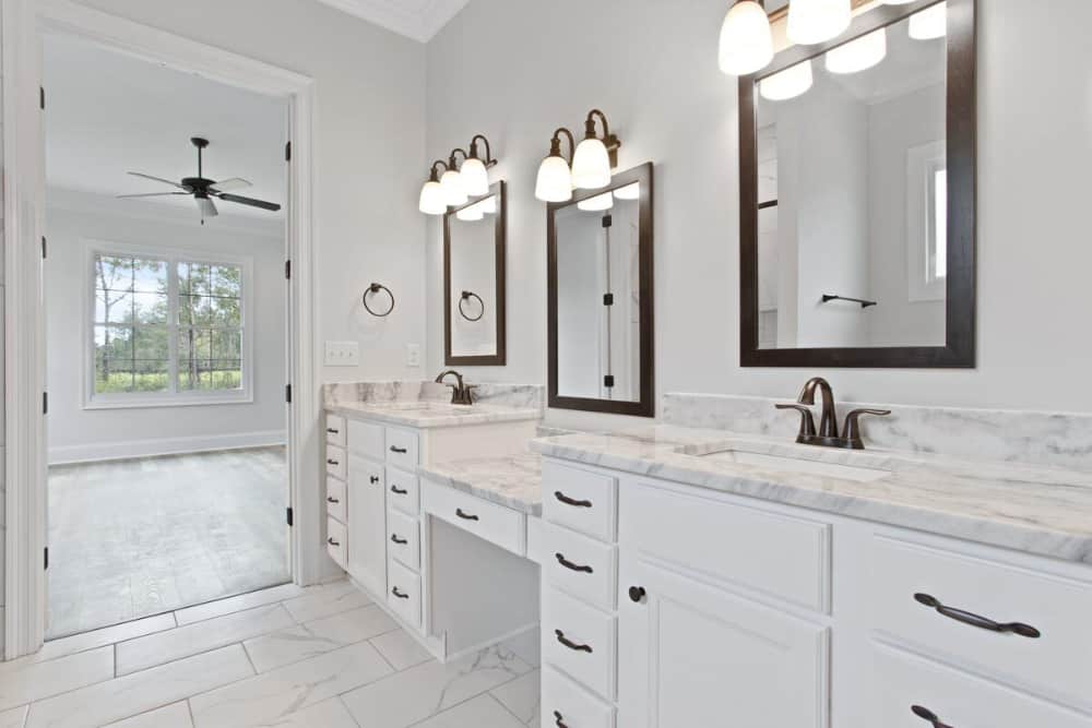 The primary bathroom features his and her sink vanities flanking the makeup counter.