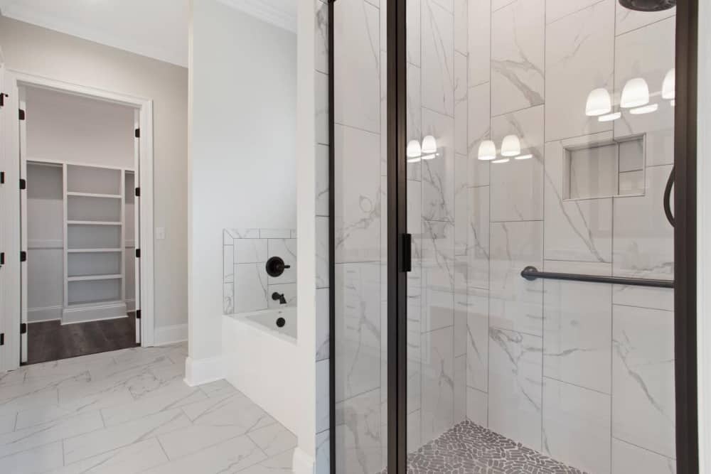 Walk-in shower and a drop-in bathtub complete the primary bathroom.