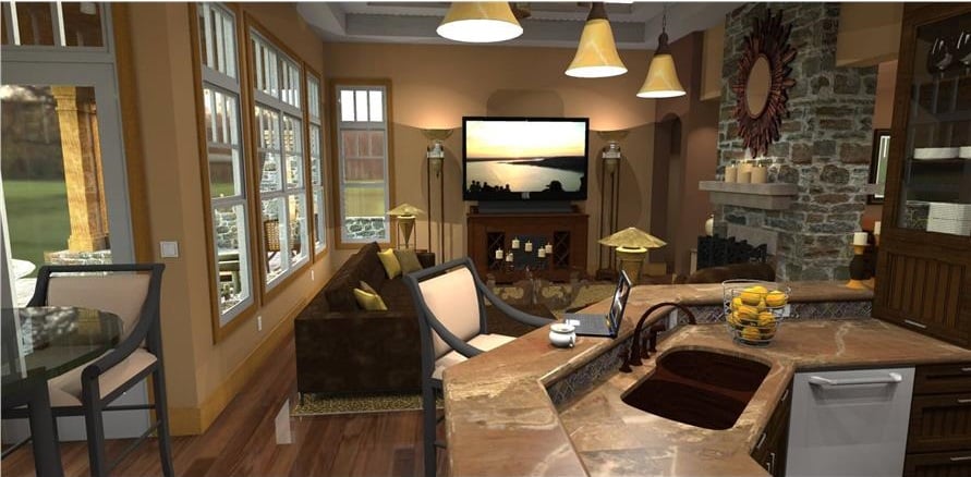 View of the family room from the kitchen showing the large TV and the stone fireplace adorned with a sunburst mirror.