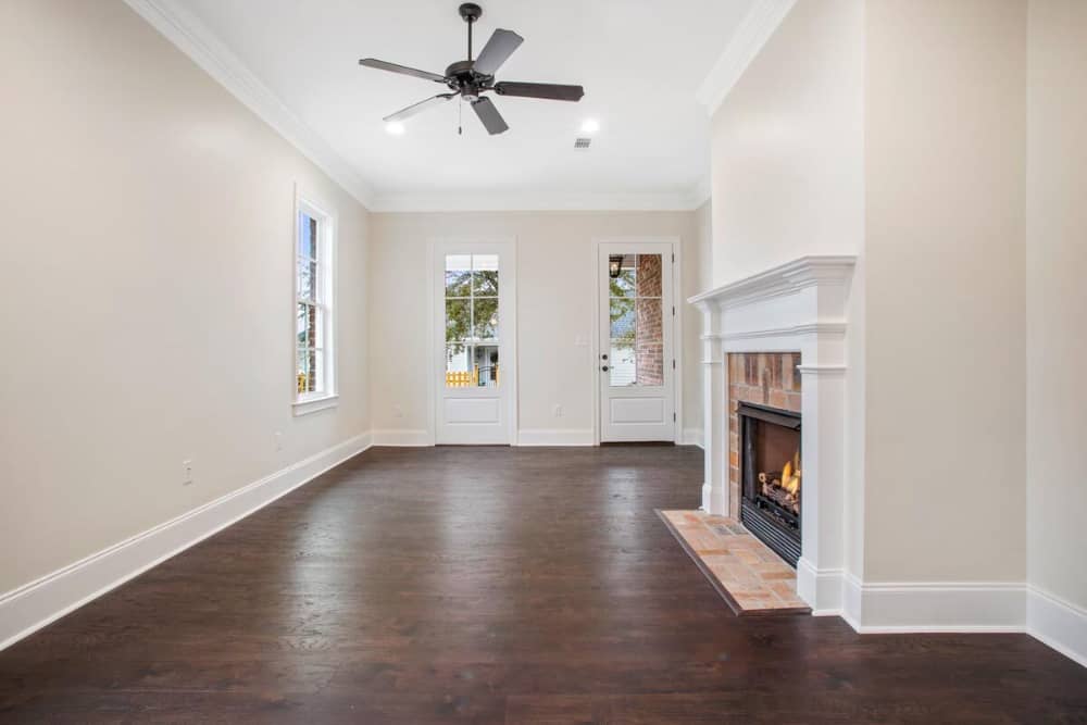 Glazed door and windows fill the living area with natural light.