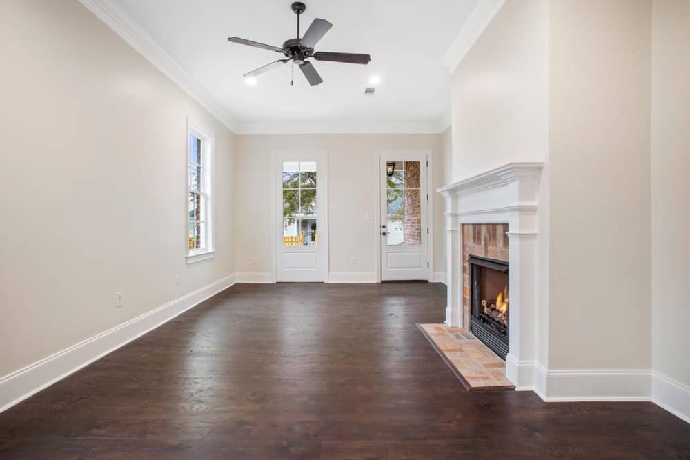 Glazed door and windows fill the living area with natural light.