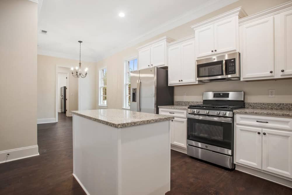 Across the kitchen is the dining space well-lit by a classic chandelier.