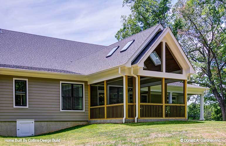 Wooden trims and railings frame the screened porch.