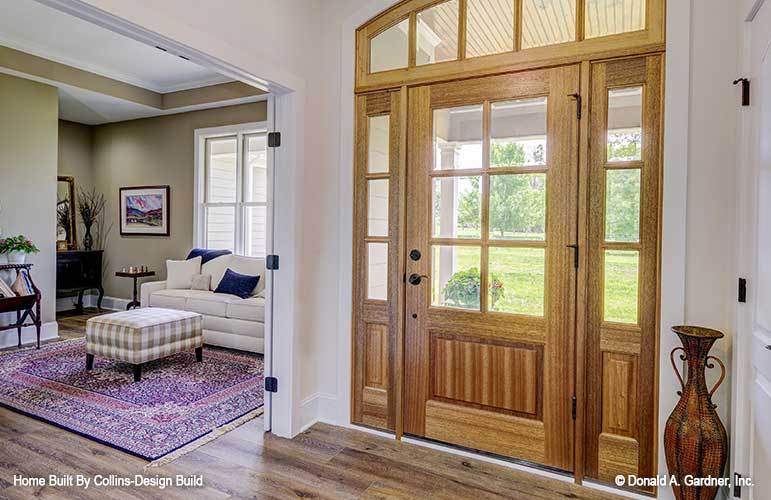 Foyer with a glazed entry door complemented with a large, decorative vase.