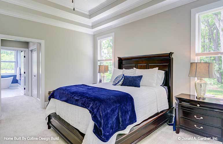 An open doorway to the left side leads to the walk-in closet and primary bathroom.