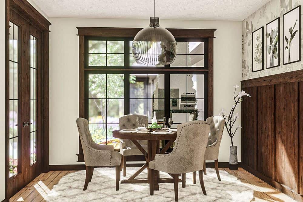 Dining area with tufted chairs and a round dining table topped with a lovely pendant light.