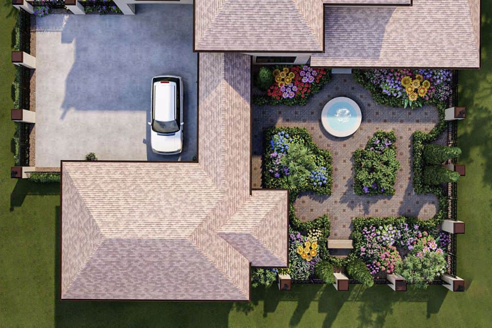 Aerial view of the French country home showing the garden and concrete driveway.