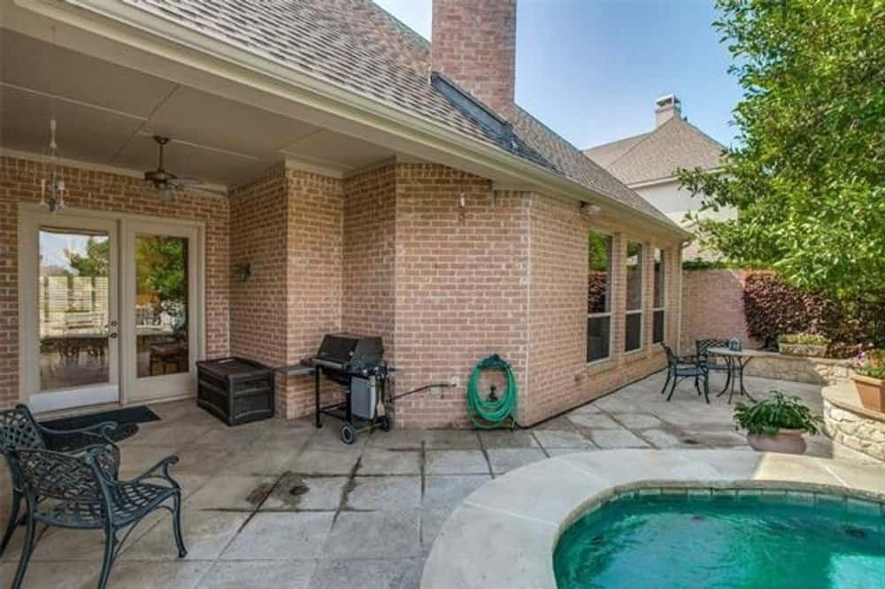 A farther view shows the outdoor dining and a glass door that opens into the main living space.
