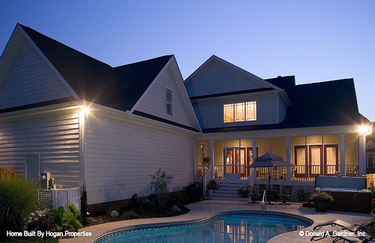 Night view of the backyard showing its stunning pool that stands out against the ambient lights.