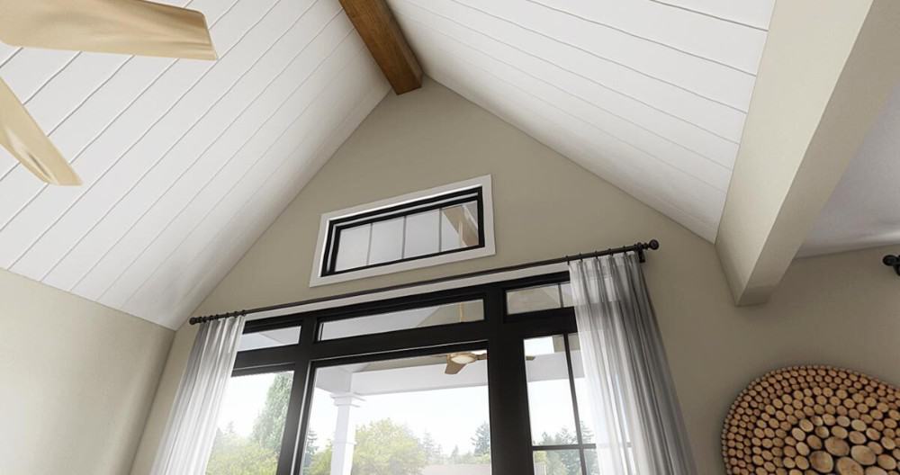 A trio of windows topped with a transom brightens the great room.