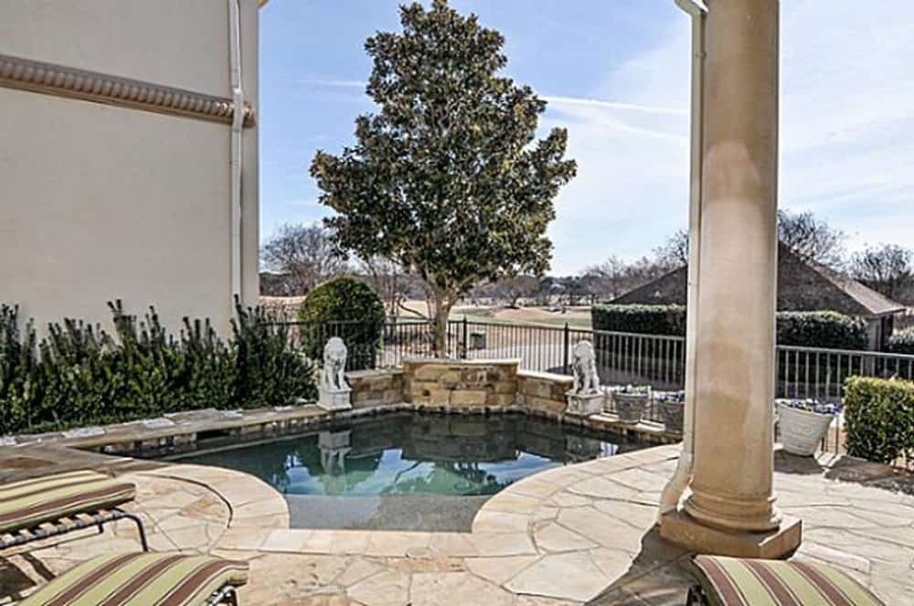 Rear patio with striped loungers and a swimming pool.