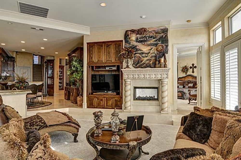 The family room includes a fireplace and a TV fitted on the wooden built-ins.