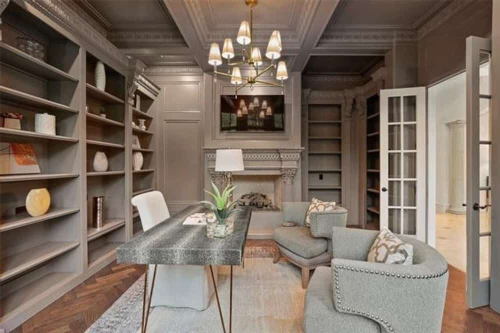 The study includes a fireplace and a wall-mounted TV.