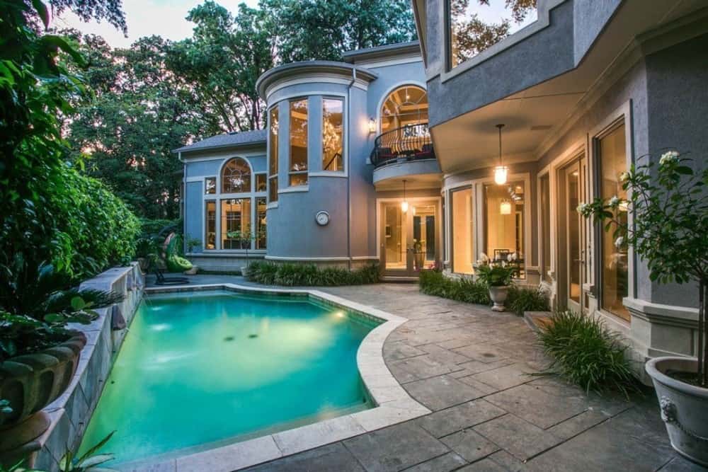 The veranda includes a swimming pool bordered by stone paving.