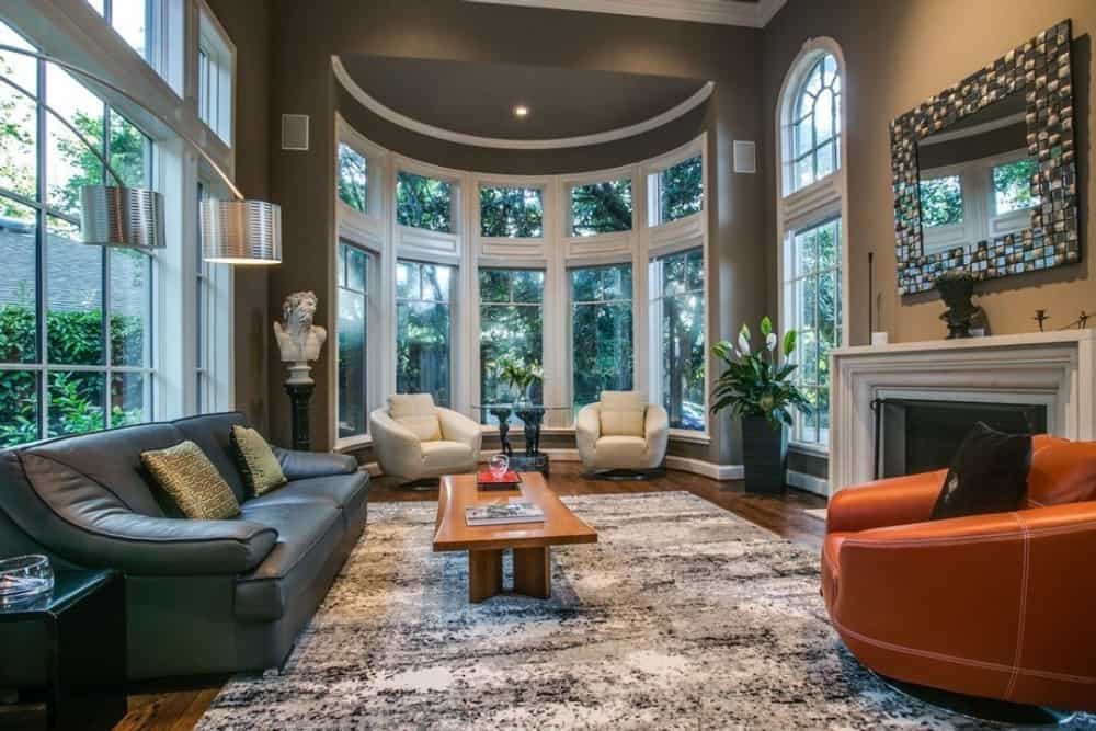The living room includes clerestory and bow windows flooding the area with natural light.