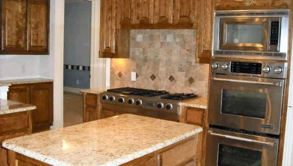 Stainless steel appliances including the wall ovens and built-in cooktop complete the kitchen.