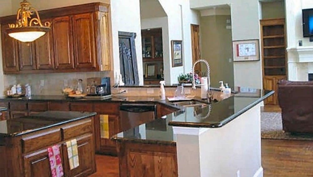 The family room opens completely into the kitchen defined with an angled peninsula with a raised eating bar.