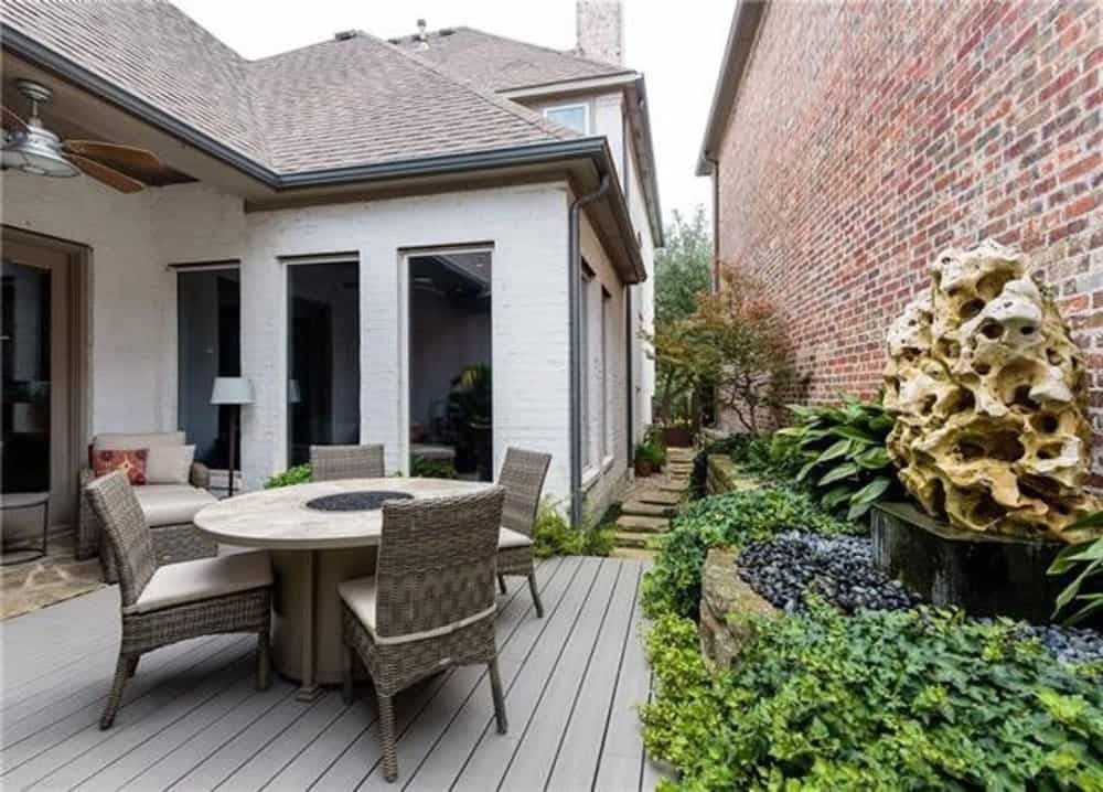 A farther view shows the stone walkway and pocket garden on the right.