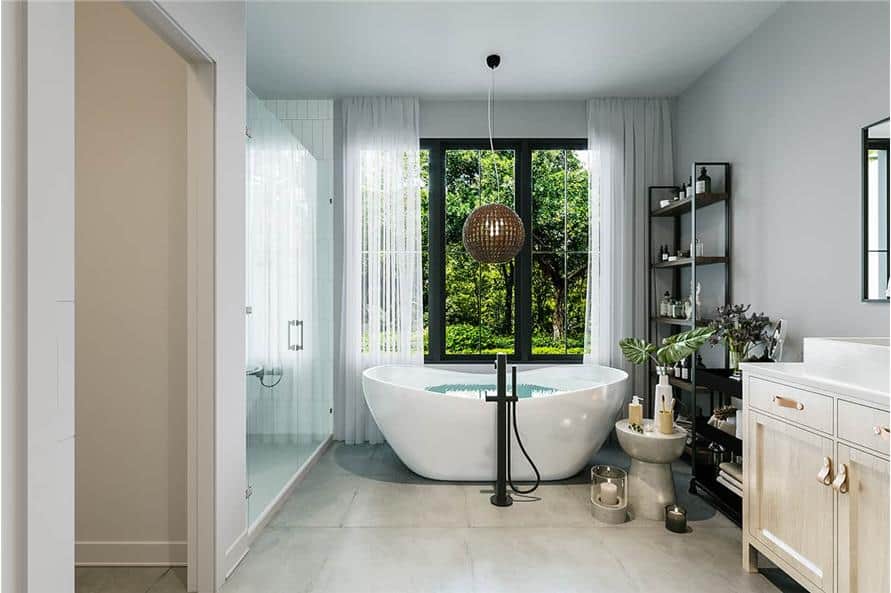 The primary bathroom is equipped with white vanity, a walk-in shower, and a freestanding tub topped with a round chandelier.