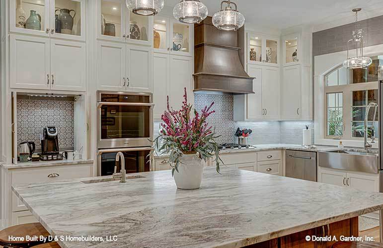 Decorative tile backsplash along with a lovely flower vase adorn the kitchen.