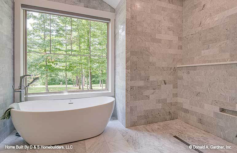 The primary bathroom includes a shower area highlighted with marble tiled walls.