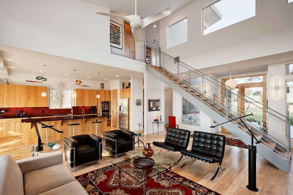 The great room opens into the kitchen equipped with sleek wooden cabinetry, stainless steel appliances, and a breakfast island.
