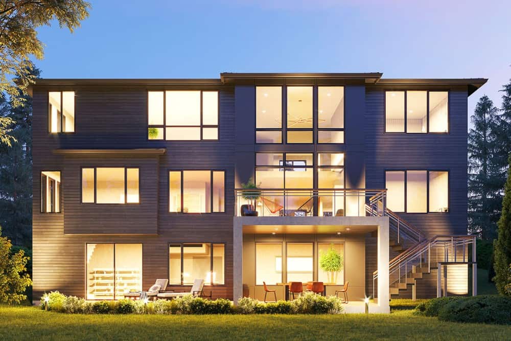 Rear rendering with expansive patio, a sun deck, and a multitude of large windows.