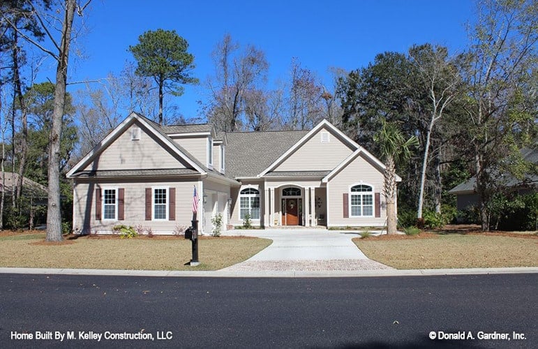 Front exterior view showing the gable rooflines, courtyard entry garage, and entry porch lined with double columns.