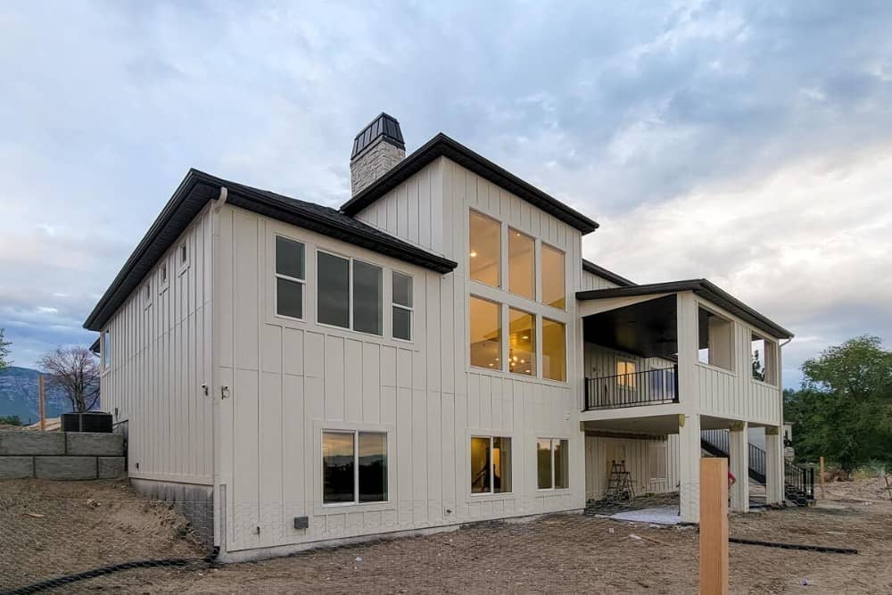 Rear exterior view showing the covered patio and deck supported by white columns.