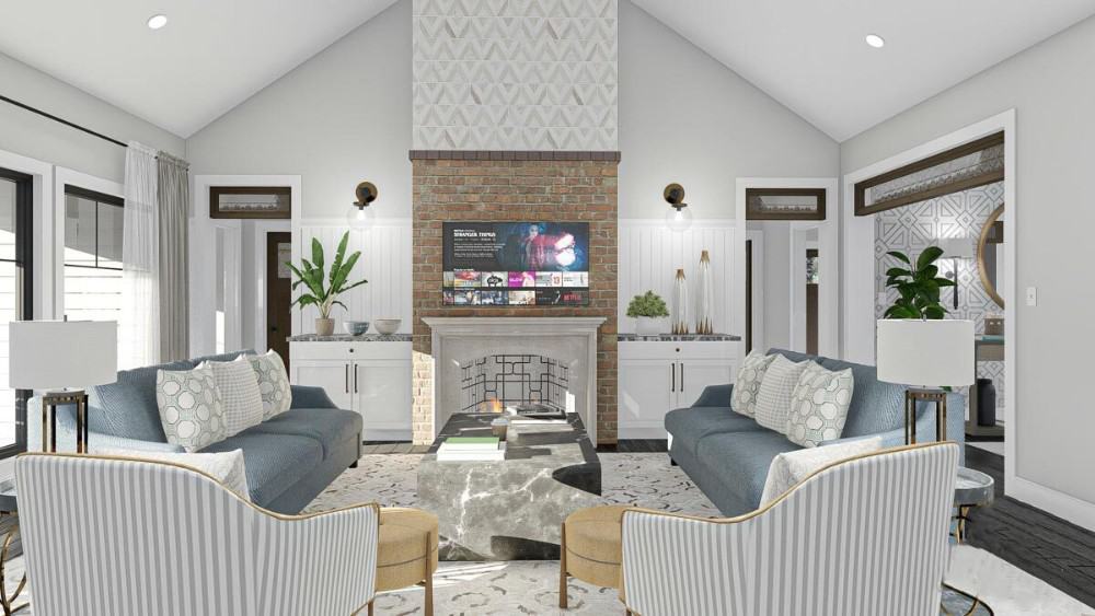 Great room with a cathedral ceiling, facing sofas, striped armchairs, and a fireplace topped with a TV.