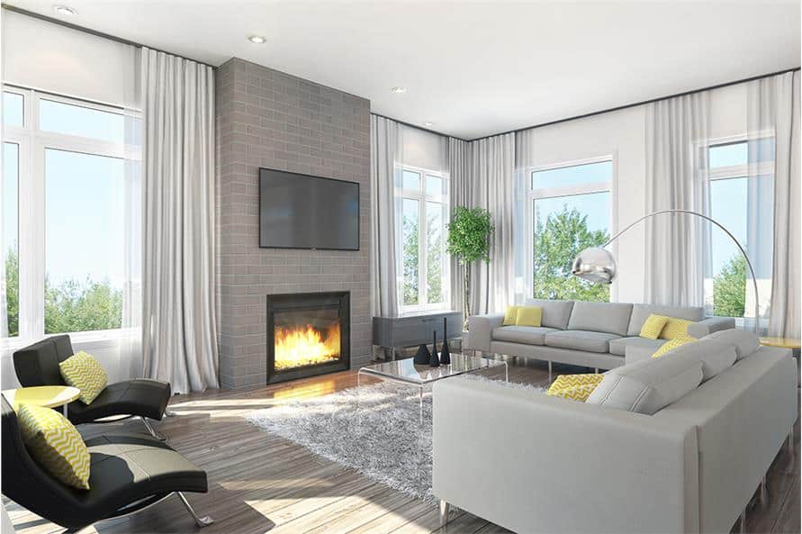 Living room with gray sofas, black leather loungers, a glass coffee table, and a modern fireplace topped with a TV.