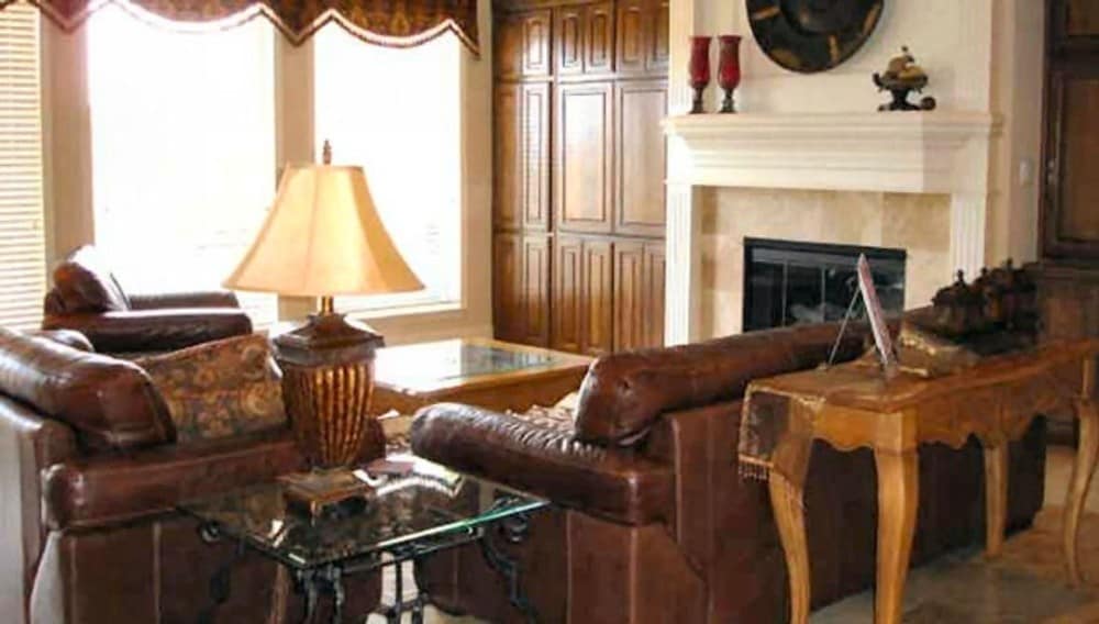 The family room includes a glass-enclosed fireplace and wooden built-ins.