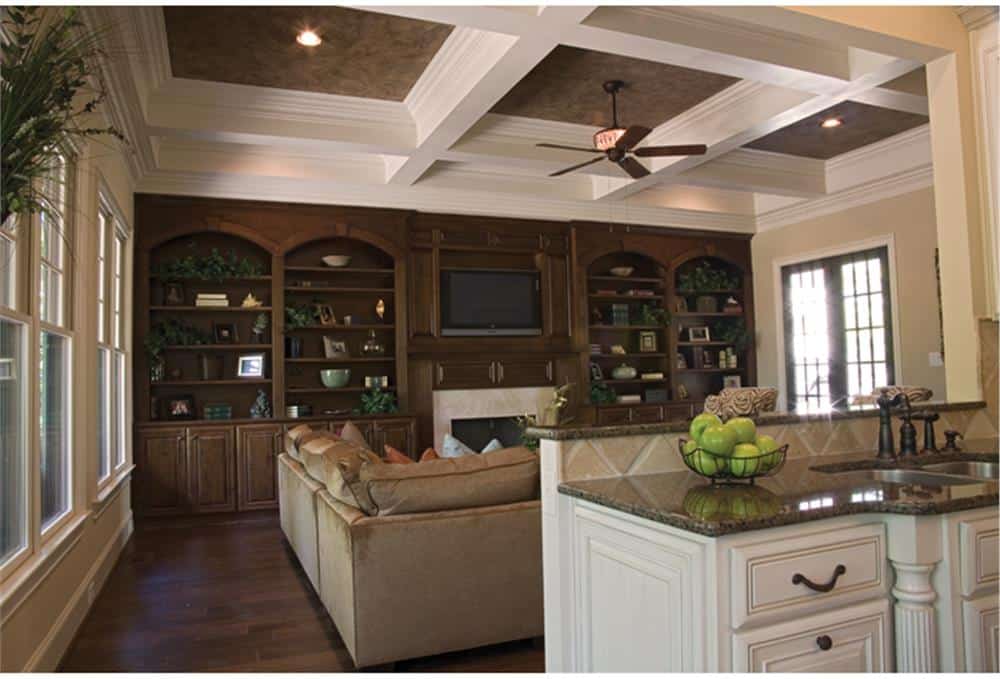 The great room includes a fireplace and TV nestled between the built-in cabinets.