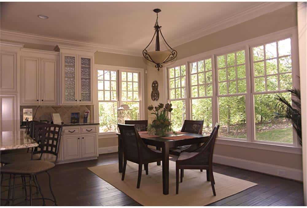 Breakfast nook with a 4-seater dining set, a glass dome pendant, and a great view of the surrounding greenery.