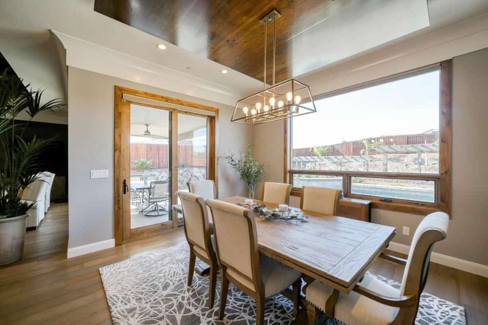 Sliding glass doors and windows invite natural light into the dining area.