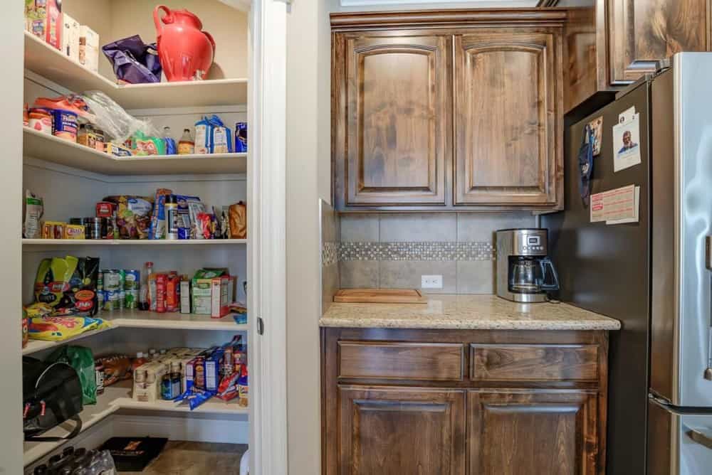 Coffee bar and a corner pantry filled with groceries complete the kitchen.